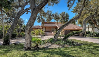 Wrapped in lush, mature landscaping and set along a tranquil on Longboat Key Golf Club Resort in Florida - for sale on GolfHomes.com, golf home, golf lot