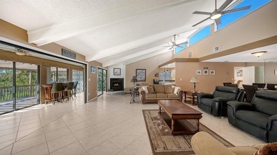 Wrapped in lush, mature landscaping and set along a tranquil on Longboat Key Golf Club Resort in Florida - for sale on GolfHomes.com, golf home, golf lot