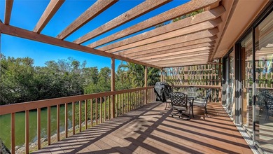Wrapped in lush, mature landscaping and set along a tranquil on Longboat Key Golf Club Resort in Florida - for sale on GolfHomes.com, golf home, golf lot