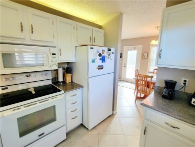 Meticulously maintained end unit with updated kitchen and baths on The American Golf Club in Florida - for sale on GolfHomes.com, golf home, golf lot