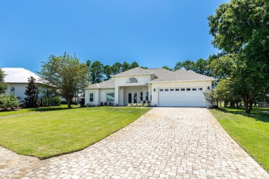 Situated on a spacious 1/2 acre lot boasting 177 ft of lake on Santa Rosa Golf and Beach Club in Florida - for sale on GolfHomes.com, golf home, golf lot