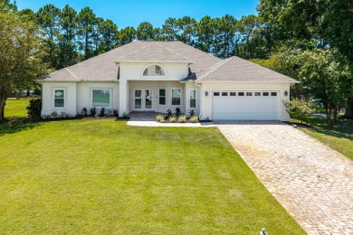 Situated on a spacious 1/2 acre lot boasting 177 ft of lake on Santa Rosa Golf and Beach Club in Florida - for sale on GolfHomes.com, golf home, golf lot