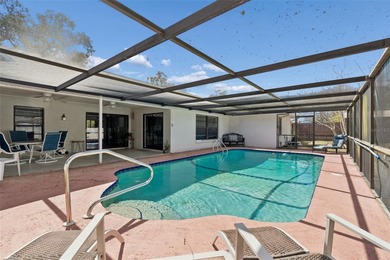 Welcome to this beautifully maintained 3-bedroom, 2-bath pool on Oak Hills Country Club in Florida - for sale on GolfHomes.com, golf home, golf lot