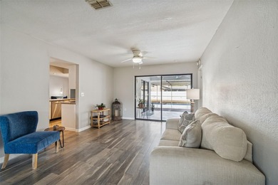 Welcome to this beautifully maintained 3-bedroom, 2-bath pool on Oak Hills Country Club in Florida - for sale on GolfHomes.com, golf home, golf lot