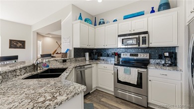 Enjoy incredible lake views from this spacious 4-bedroom, 3-bath on Tan-Tar-A Golf Club in Missouri - for sale on GolfHomes.com, golf home, golf lot