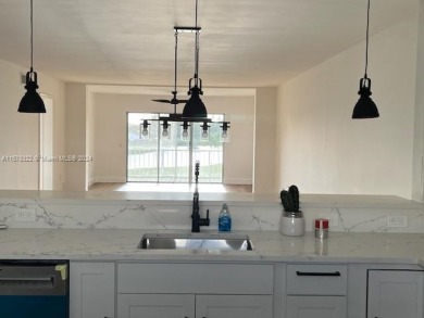 This beautifully remodeled unit is move in ready, it's a must on Atlantis Golf Club in Florida - for sale on GolfHomes.com, golf home, golf lot