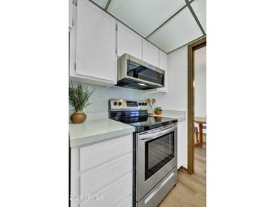 Beautifully updated patio-style townhouse offering modern on PalmBrook Country Club in Arizona - for sale on GolfHomes.com, golf home, golf lot