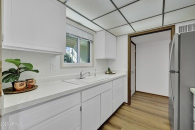 Beautifully updated patio-style townhouse offering modern on PalmBrook Country Club in Arizona - for sale on GolfHomes.com, golf home, golf lot