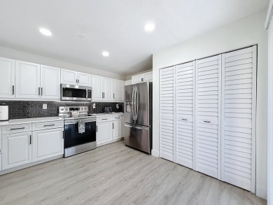 This beautifully renovated 2-bedroom, 2.5-bathroom townhouse on Woodmont Country Club in Florida - for sale on GolfHomes.com, golf home, golf lot