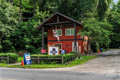 Welcome to your dream cabin nestled in the highly sought-after on Rumbling Bald Resort on Lake Lure in North Carolina - for sale on GolfHomes.com, golf home, golf lot