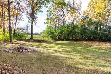 Enjoy the convenience of single level living in this beautiful on St. Clair Shores Country Club in Michigan - for sale on GolfHomes.com, golf home, golf lot