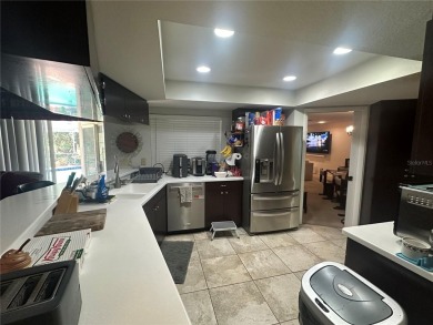 Welcome to this spacious 4-bedroom, 3-bath traditional home on Mangrove Bay Golf Course in Florida - for sale on GolfHomes.com, golf home, golf lot