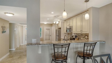 Rarely available 3-bedroom end unit featuring sweeping golf on Palm Aire Country Club of Sarasota in Florida - for sale on GolfHomes.com, golf home, golf lot