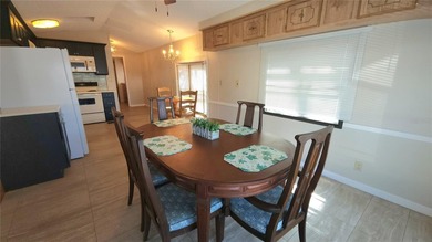 TWO BEDROOM, ONE BATHROOM MOBILE HOME IN AN ACTIVE 55+ COMMUNITY on River Run Golf Links in Florida - for sale on GolfHomes.com, golf home, golf lot