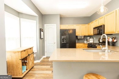 Welcome to this beautifully maintained three-level end-unit on Sugar Hill Golf Club in Georgia - for sale on GolfHomes.com, golf home, golf lot
