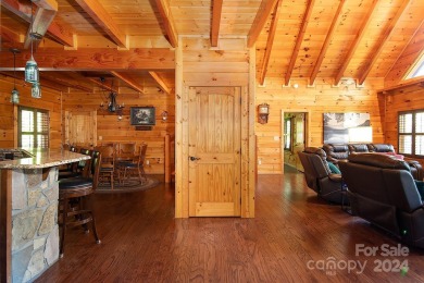 Discover this exceptional 1.5-story log home nestled in a on Lake Louise Golf Club in North Carolina - for sale on GolfHomes.com, golf home, golf lot