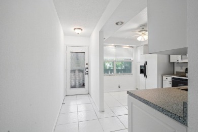 Best priced unit with impact windows! Stunning waterfront 2 on Wynmoor Golf Course in Florida - for sale on GolfHomes.com, golf home, golf lot