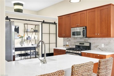 Gorgeous, spacious end unit with views of trees and water on The Rookery At Marco in Florida - for sale on GolfHomes.com, golf home, golf lot