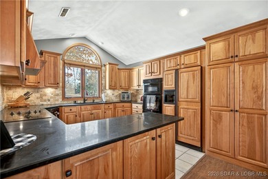 This stunning lakefront home in Four Seasons offers 75 feet of on Seasons Ridge At Four Seasons in Missouri - for sale on GolfHomes.com, golf home, golf lot