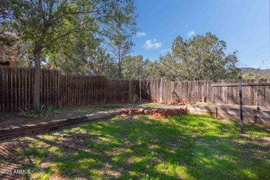 Charming house nestled among mature trees on a quiet street on Canyon Mesa Country Club in Arizona - for sale on GolfHomes.com, golf home, golf lot