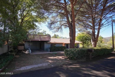 Charming house nestled among mature trees on a quiet street on Canyon Mesa Country Club in Arizona - for sale on GolfHomes.com, golf home, golf lot