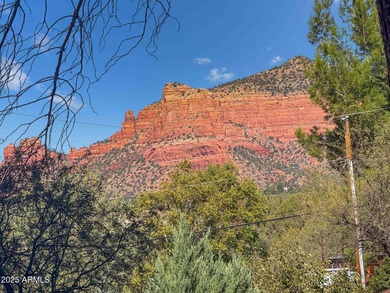 Charming house nestled among mature trees on a quiet street on Canyon Mesa Country Club in Arizona - for sale on GolfHomes.com, golf home, golf lot