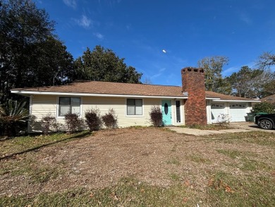 This 3 bedroom home is located in Diamondhead. Wood burning on Diamondhead Country Club in Mississippi - for sale on GolfHomes.com, golf home, golf lot