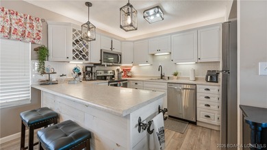 Beautifully updated waterfront condominium with stunning lake on Seasons Ridge At Four Seasons in Missouri - for sale on GolfHomes.com, golf home, golf lot