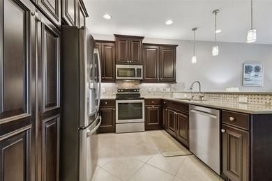 An opportunity to own a Nantucket model villa with a water view on Caloosa Greens Executive Golf Course in Florida - for sale on GolfHomes.com, golf home, golf lot