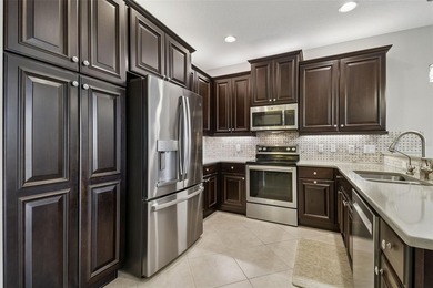 An opportunity to own a Nantucket model villa with a water view on Caloosa Greens Executive Golf Course in Florida - for sale on GolfHomes.com, golf home, golf lot