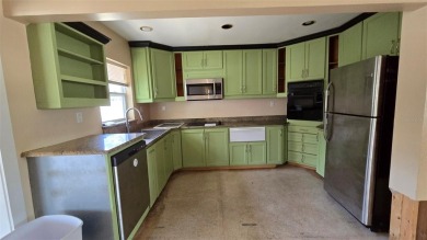 This home is located in Dana Shores - a very popular waterfront on Rocky Point Golf Course in Florida - for sale on GolfHomes.com, golf home, golf lot