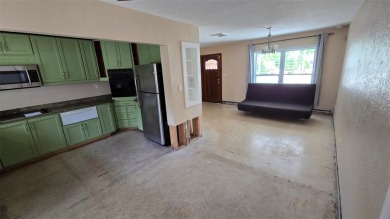 This home is located in Dana Shores - a very popular waterfront on Rocky Point Golf Course in Florida - for sale on GolfHomes.com, golf home, golf lot