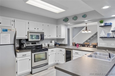 Experience unparalleled lakefront living with this stunning on The Oaks Golf Course in Missouri - for sale on GolfHomes.com, golf home, golf lot