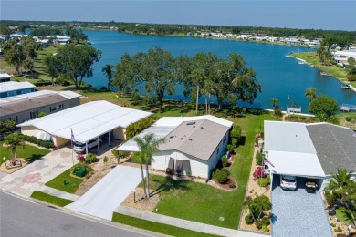 This beautifully updated lakefront retreat with a private dock on Imperial Lakewoods Golf Club in Florida - for sale on GolfHomes.com, golf home, golf lot