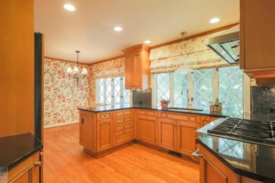 Discover the ease of single-level living with stunning vistas of on Country Club of Detroit - Regulation in Michigan - for sale on GolfHomes.com, golf home, golf lot
