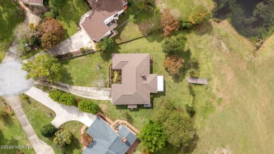 Welcome to this stunning 3-bedroom, 2.5-bathroom brick ranch on Harbour Point Golf Club in North Carolina - for sale on GolfHomes.com, golf home, golf lot
