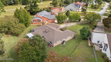 Welcome to this stunning 3-bedroom, 2.5-bathroom brick ranch on Harbour Point Golf Club in North Carolina - for sale on GolfHomes.com, golf home, golf lot