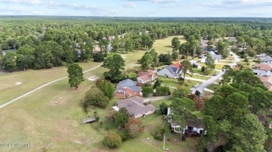 Welcome to this stunning 3-bedroom, 2.5-bathroom brick ranch on Harbour Point Golf Club in North Carolina - for sale on GolfHomes.com, golf home, golf lot