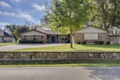 This 3-bedroom, 2-bathroom home is nestled in the highly coveted on Pecan Plantation Country Club in Texas - for sale on GolfHomes.com, golf home, golf lot