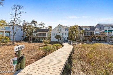 Prepare to be captivated by this extraordinary waterfront on Oak Island Golf Club in North Carolina - for sale on GolfHomes.com, golf home, golf lot