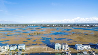 Situated in a private gated community overlooking one of Sunset on Oyster Bay Golf Links in North Carolina - for sale on GolfHomes.com, golf home, golf lot