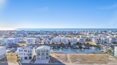 Situated in a private gated community overlooking one of Sunset on Oyster Bay Golf Links in North Carolina - for sale on GolfHomes.com, golf home, golf lot