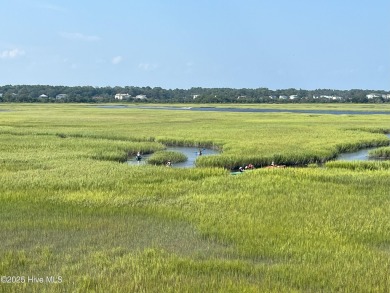 Situated in a private gated community overlooking one of Sunset on Oyster Bay Golf Links in North Carolina - for sale on GolfHomes.com, golf home, golf lot