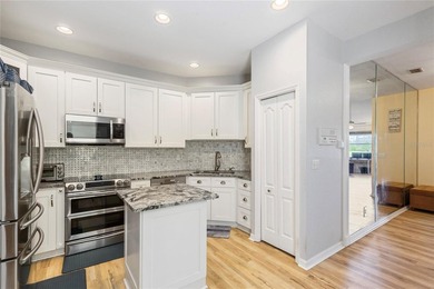 Wake up each morning to peaceful golf course views in this on East Bay Golf Club in Florida - for sale on GolfHomes.com, golf home, golf lot