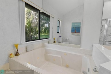 RESORT STYLE LIVING.  THIS RARELY AVAILABLE REMODELED VILLA WITH on Boca West Golf and Country Club in Florida - for sale on GolfHomes.com, golf home, golf lot