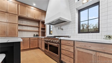 Recently completed by Thomas Construction, this luxury residence on The Oaks Golf Course in Missouri - for sale on GolfHomes.com, golf home, golf lot