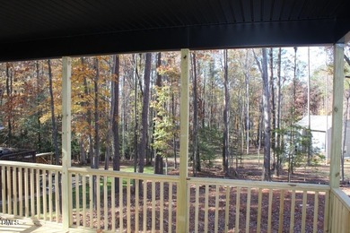 Experience the ultimate resort lifestyle in this move-in ready on River Golf and Country Club at Lake Royale in North Carolina - for sale on GolfHomes.com, golf home, golf lot