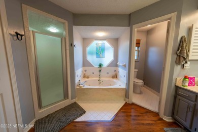 Fantastic pool home tucked away in a quiet Fort Caroline on Hidden Hills Country Club in Florida - for sale on GolfHomes.com, golf home, golf lot