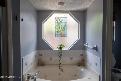 Fantastic pool home tucked away in a quiet Fort Caroline on Hidden Hills Country Club in Florida - for sale on GolfHomes.com, golf home, golf lot
