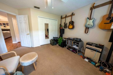 Fantastic pool home tucked away in a quiet Fort Caroline on Hidden Hills Country Club in Florida - for sale on GolfHomes.com, golf home, golf lot